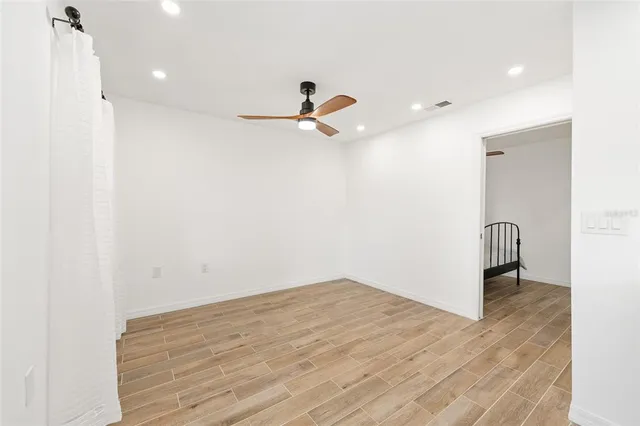 a view of a room with a sink and a ceiling fan