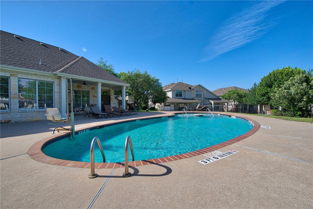 1900 Scofield Ridge Parkway, Unit 5501 Austin, TX 78727 - Photo 18 of 21 An inviting pool area awaits, flanked by a charming covered patio and residential backdrop.