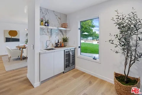 a kitchen with a window and wooden floor