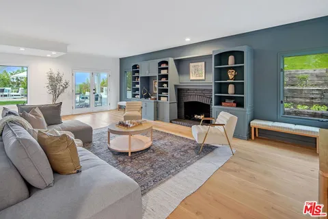 a living room with furniture fireplace and window