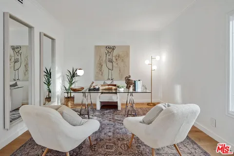 a living room with furniture and a potted plant