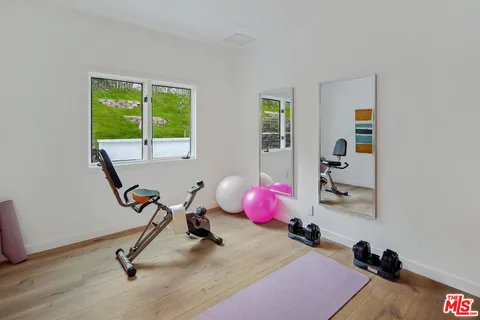 a room with gym equipment and a window