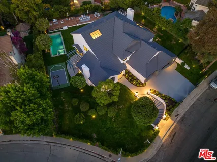 an aerial view of a house with garden space and street view