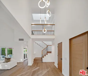 a view of entryway livingroom and hall with wooden floor