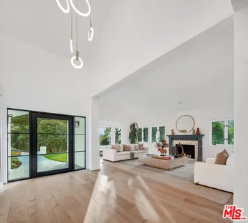 a view of a livingroom with furniture fireplace and a window