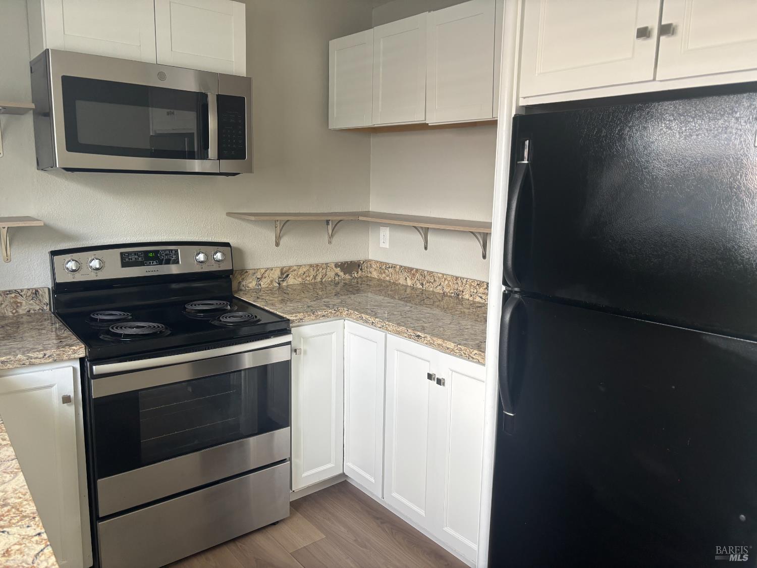 221 College View Drive Rohnert Park, CA 94928 - Photo 4 of 12 a kitchen with stainless steel appliances granite countertop white cabinets and black appliances
