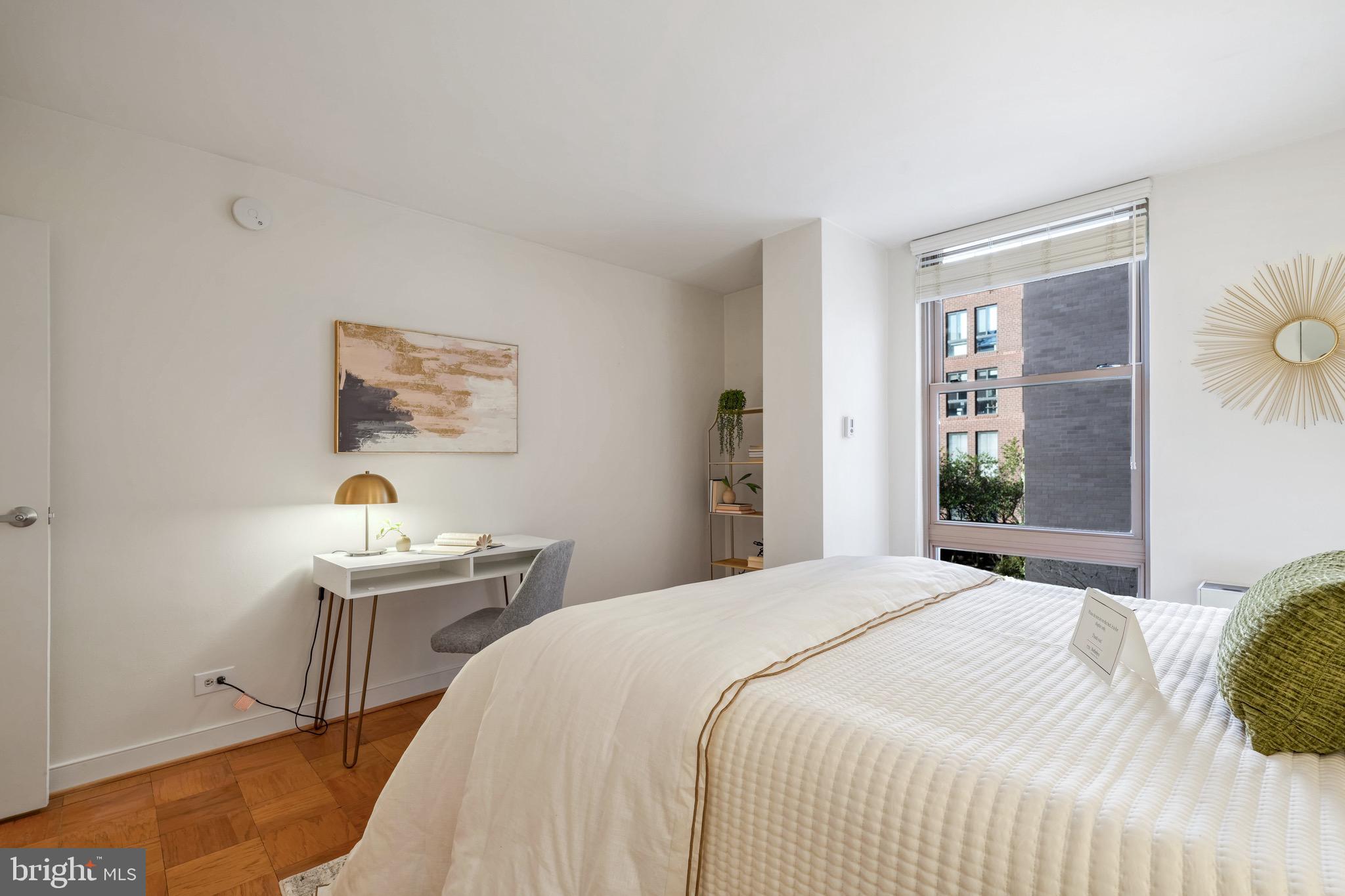 1260 21st Street Northwest, Unit 208 Washington, DC 20036 - Photo 12 of 25 a bedroom with a bed and a table in it