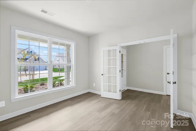 an empty room with windows and closet