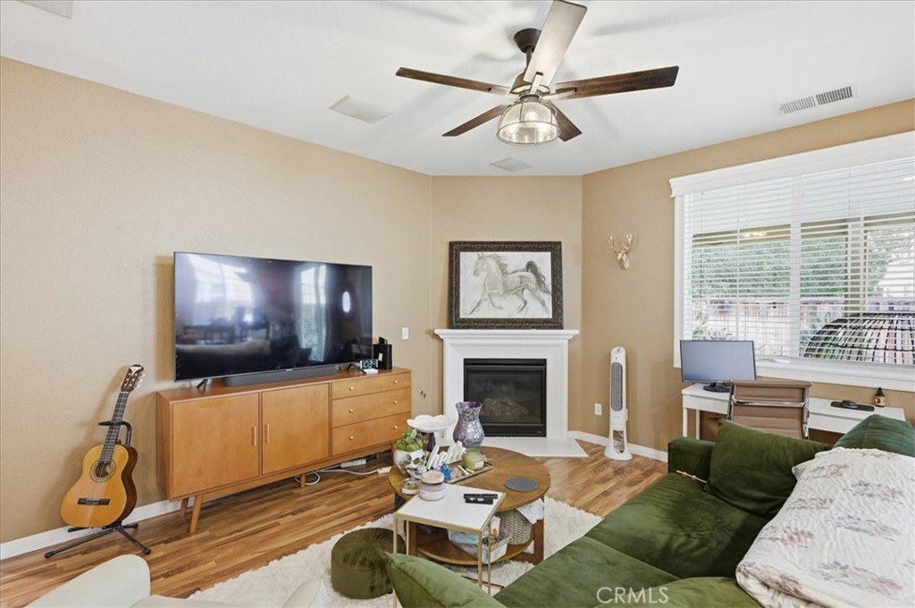 32623 Ritter Court Temecula, CA 92592 - Photo 18 of 40 a living room with furniture a flat screen tv and a floor to ceiling window