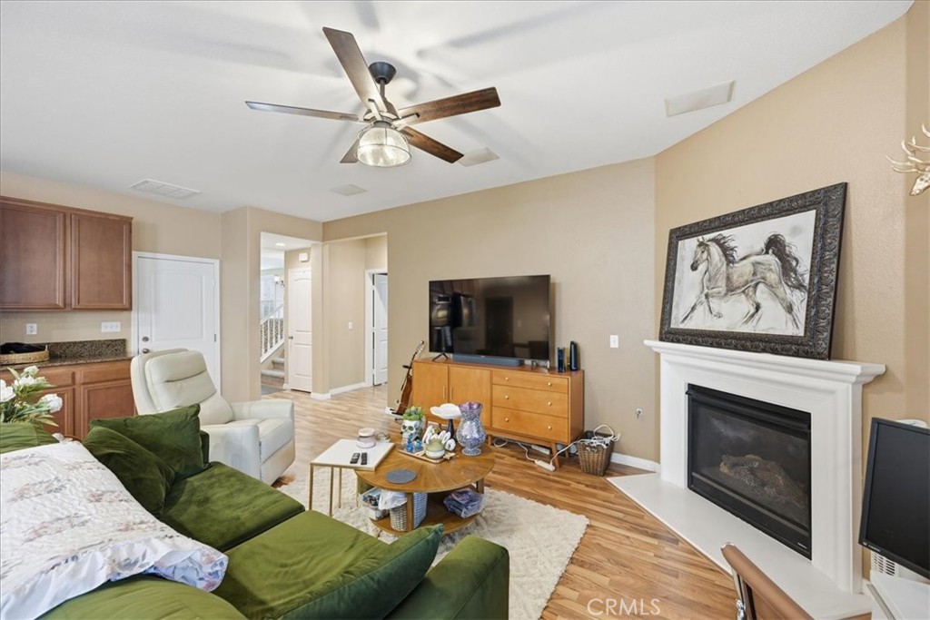 32623 Ritter Court Temecula, CA 92592 - Photo 19 of 40 a living room with furniture a flat screen tv and a fireplace