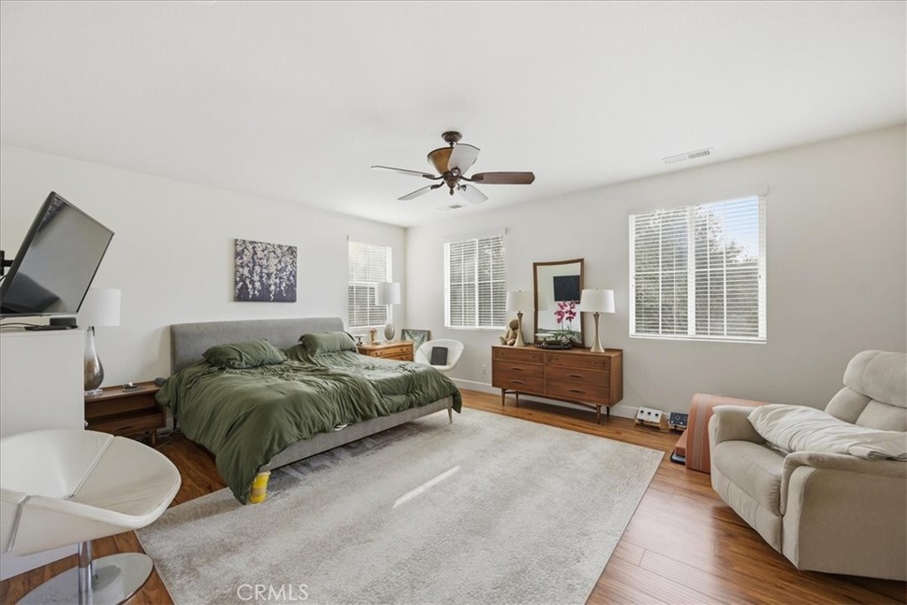 32623 Ritter Court Temecula, CA 92592 - Photo 26 of 40 a spacious bedroom with a bed a couch and a window