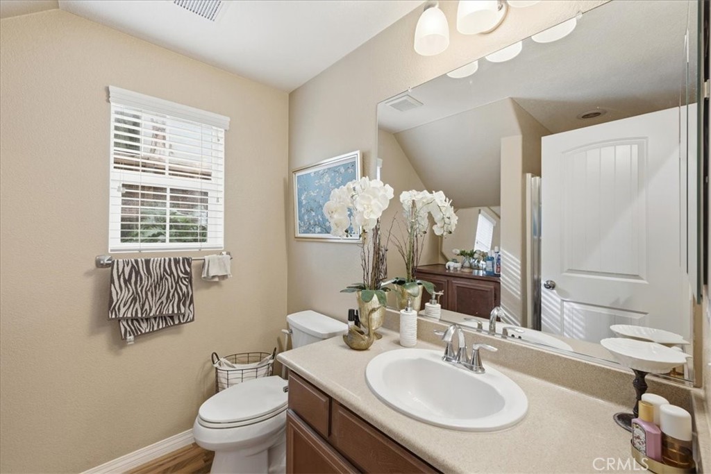 32623 Ritter Court Temecula, CA 92592 - Photo 31 of 40 a bathroom with a sink vanity mirror and toilet
