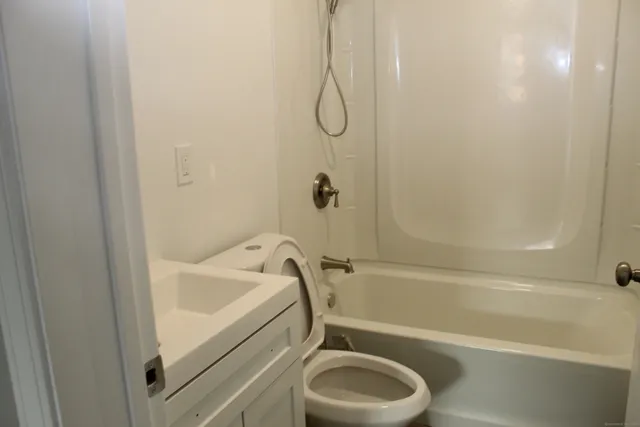 a bathroom with a tub and a shower