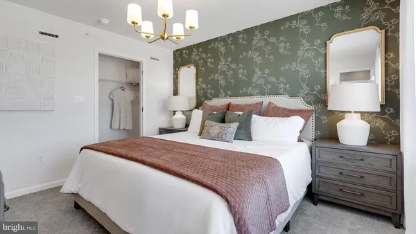 a bedroom with a bed and a mirror