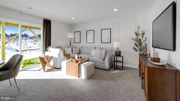 a living room with furniture a chandelier and a flat screen tv