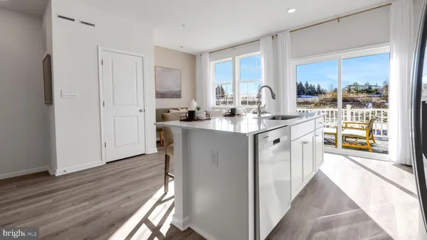 a kitchen with sink cabinets and wooden floor