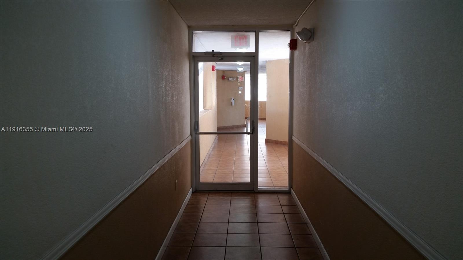 2075 Southwest 122nd Avenue, Unit 402 Miami, FL 33175 - Photo 18 of 36 a view of a hallway with wooden floor and a window