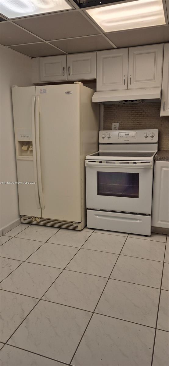 2075 Southwest 122nd Avenue, Unit 402 Miami, FL 33175 - Photo 26 of 36 a stove top oven sitting inside of a kitchen