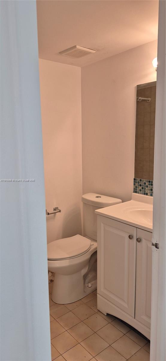2075 Southwest 122nd Avenue, Unit 402 Miami, FL 33175 - Photo 32 of 36 a bathroom with a granite countertop toilet and a sink