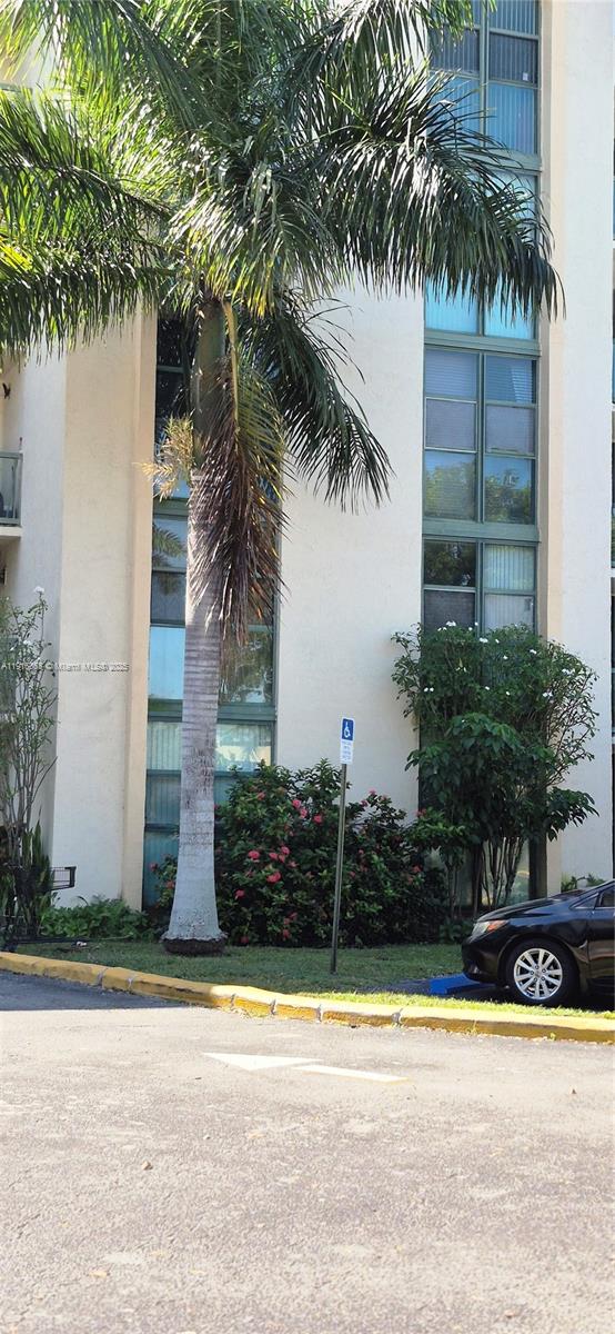 2075 Southwest 122nd Avenue, Unit 402 Miami, FL 33175 - Photo 7 of 36 a front view of a house with a garden and plants