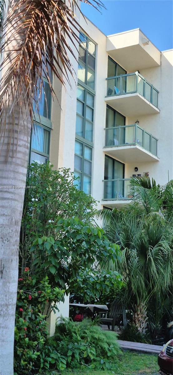 2075 Southwest 122nd Avenue, Unit 402 Miami, FL 33175 - Photo 8 of 36 a view of a brick building next to a yard