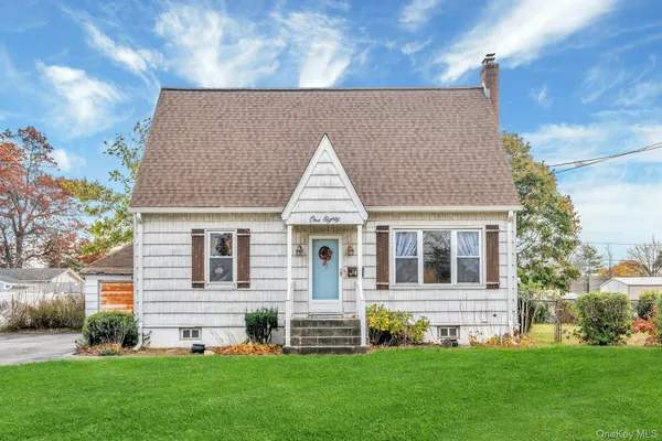 a front view of a house with a garden and yard