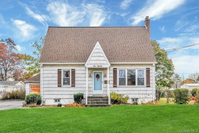 a front view of a house with a garden and yard