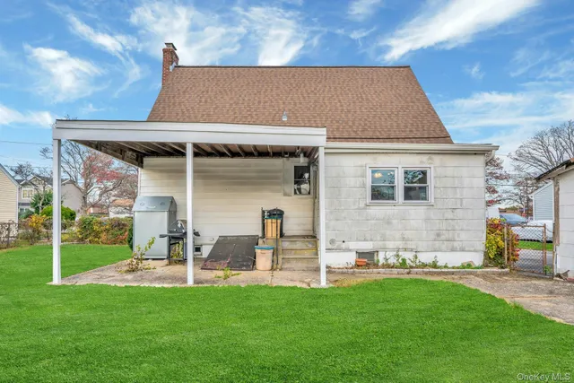 a view of a house with a yard and sitting area