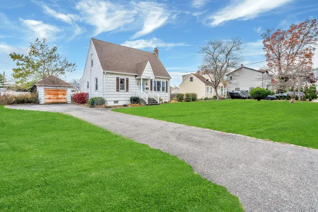 a front view of house with yard and green space