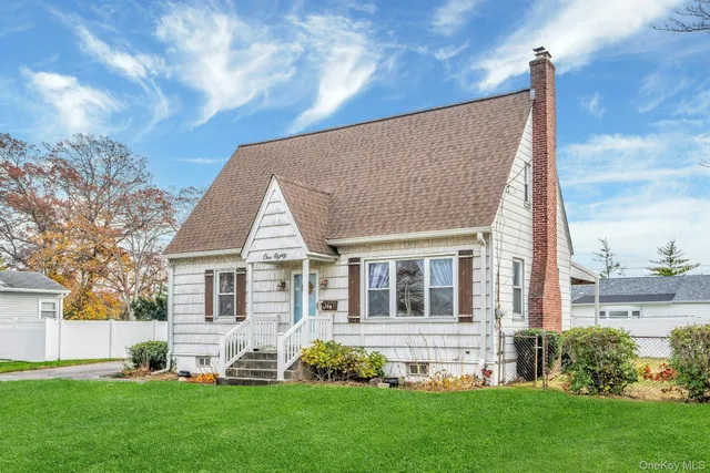 a front view of a house with a garden and yard