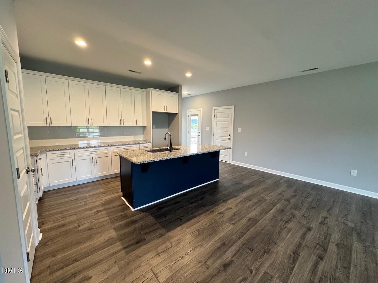 9 Alex Acres Way Selma, NC 27576 - Photo 5 of 26 a kitchen with kitchen island sink stove and cabinets