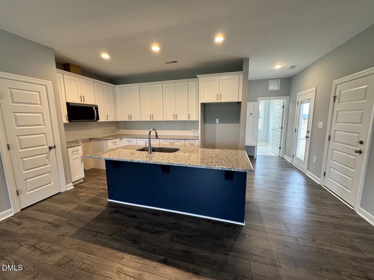 9 Alex Acres Way Selma, NC 27576 - Photo 8 of 26 a kitchen with kitchen island a sink stainless steel appliances and cabinets