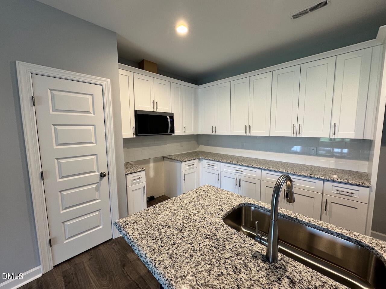 9 Alex Acres Way Selma, NC 27576 - Photo 9 of 26 a kitchen with a refrigerator sink and cabinets