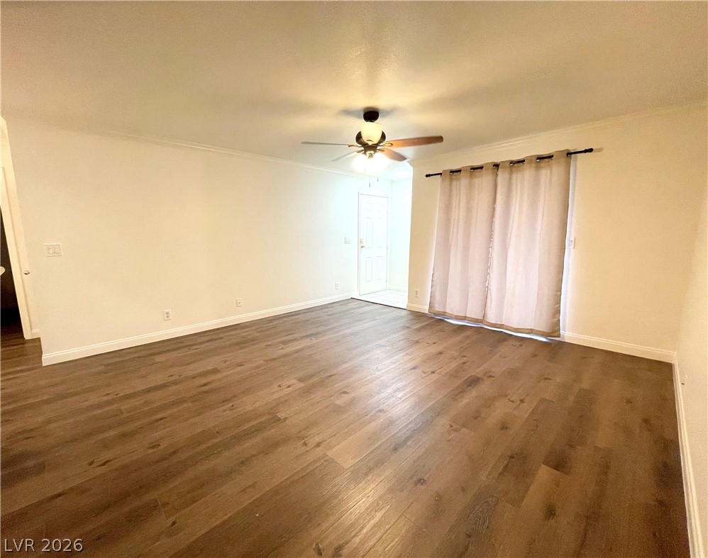 3135 South Mojave Road, Unit 221 Las Vegas, NV 89121 - Photo 2 of 19 Rich hardwood-style flooring extends across this spacious, naturally illuminated room, complemented by a ceiling fan for comfort.