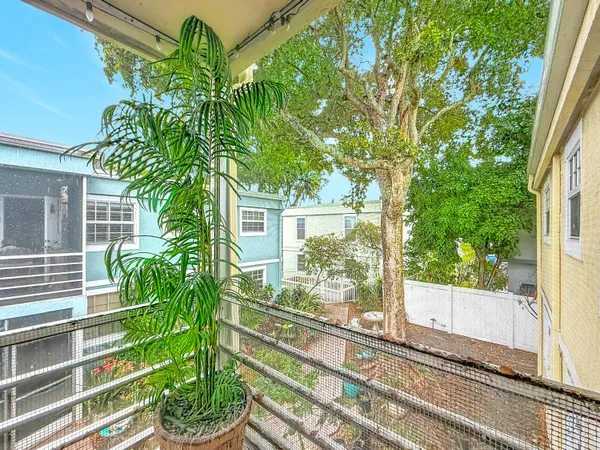 a view of a backyard with chair potted plants