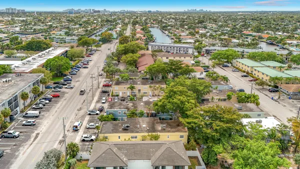an aerial view of residential houses with outdoor space