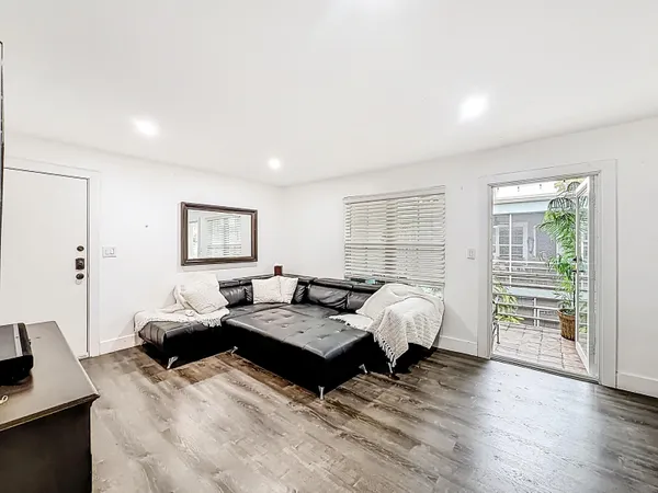 a living room with furniture and wooden floor