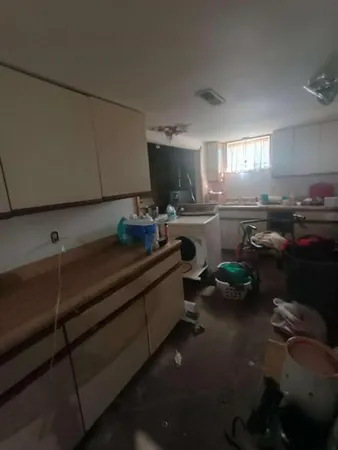 a kitchen with a sink cabinets and appliances