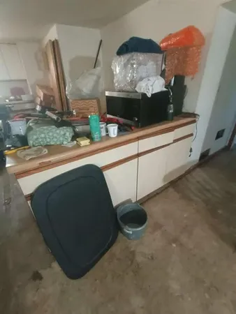a room with water heater and wooden walls