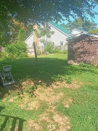 a backyard of a house with table and chairs