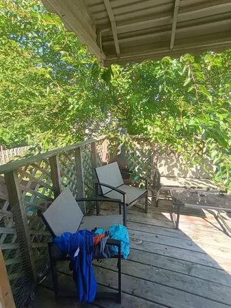 a backyard of a house with table and chairs