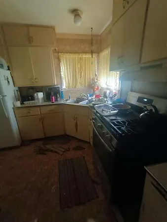 a kitchen with sink stove and cabinets