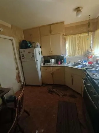 a kitchen with a sink stove and cabinets