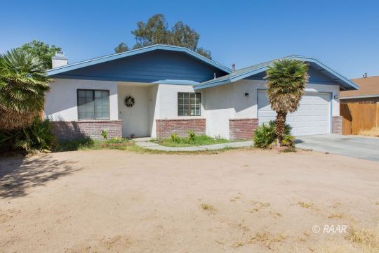 600 Beth Lane Ridgecrest, CA 93555 - Photo 2 of 25 a front view of a house with a yard and garage