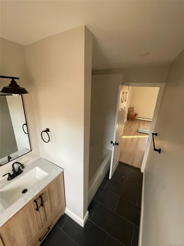 a bathroom with a sink mirror and toilet