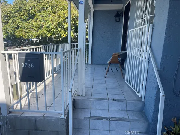 a view of balcony with wooden floor and outdoor seating