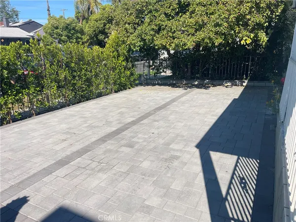 a terrace with trees in front of it