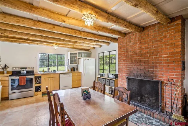 a dining room with furniture and a fireplace