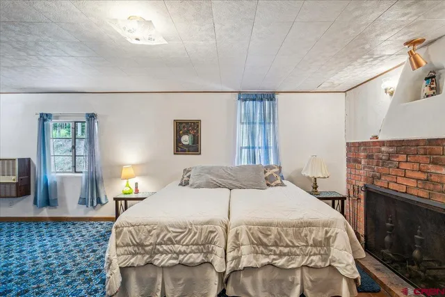 a bedroom with a bed and a couch