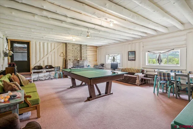 a living room with furniture a wooden floor and potted plant